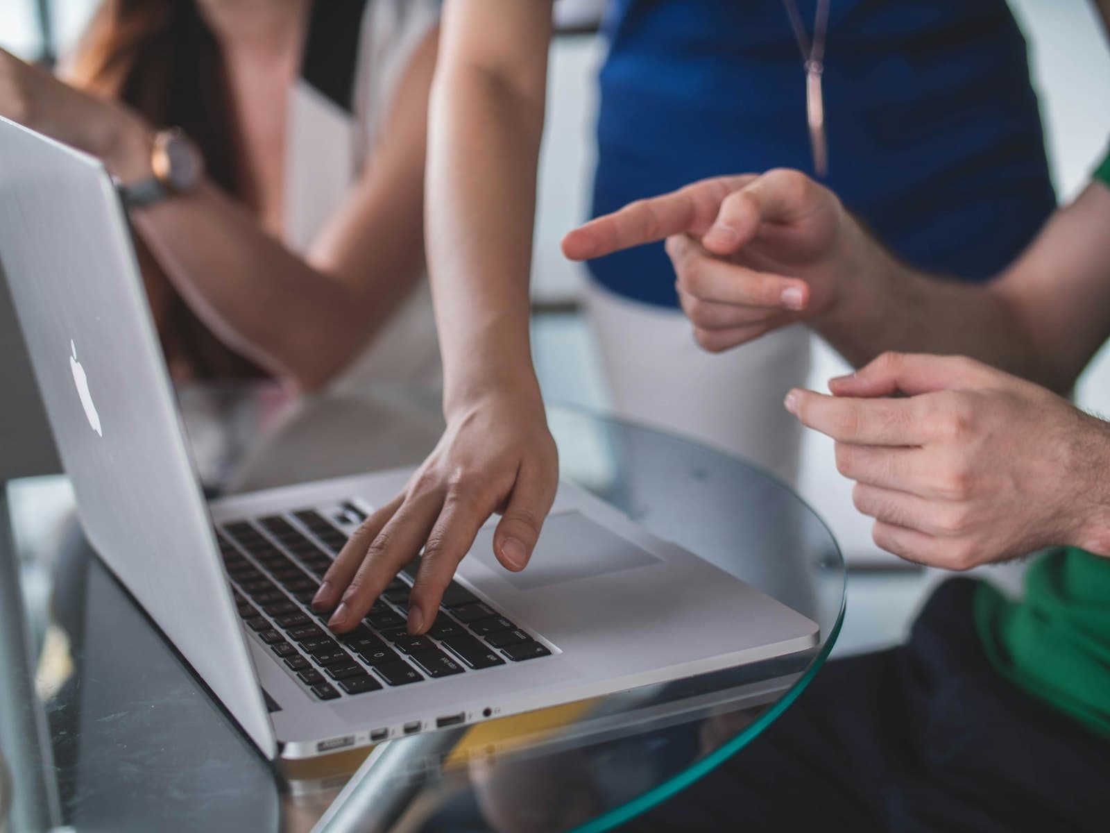 Hands pointing at a laptop during a working session